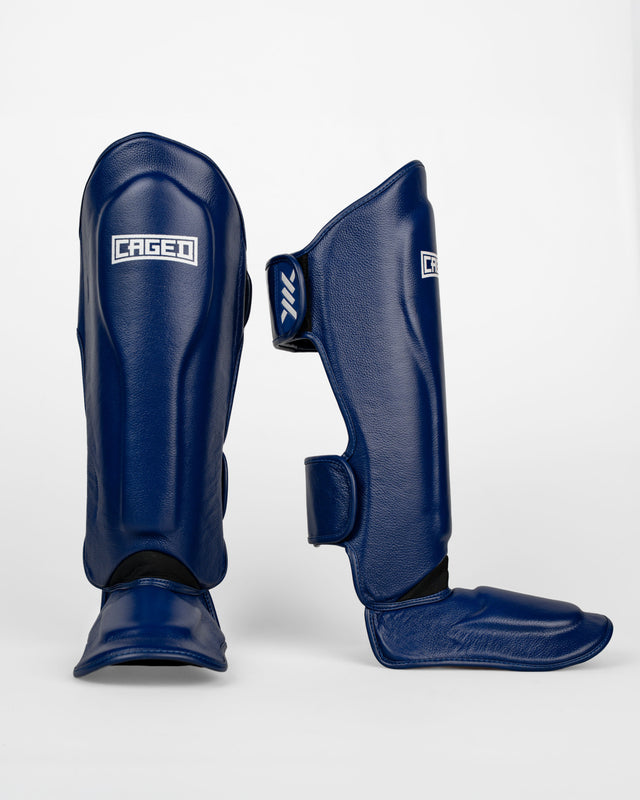 Caged Benskydd 'X' Series – Navy Blå/Vit