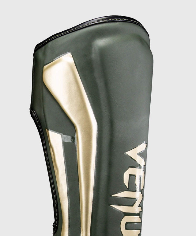 Espinilleras Venum Elite – Caqui/Oro