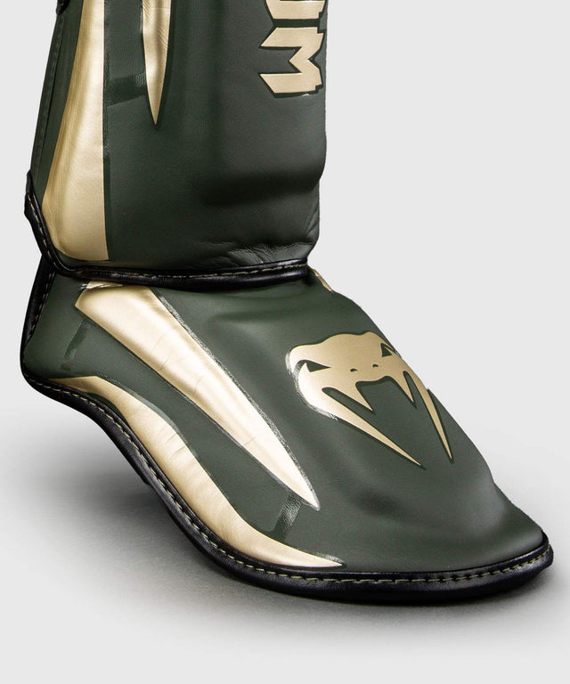 Espinilleras Venum Elite – Caqui/Oro